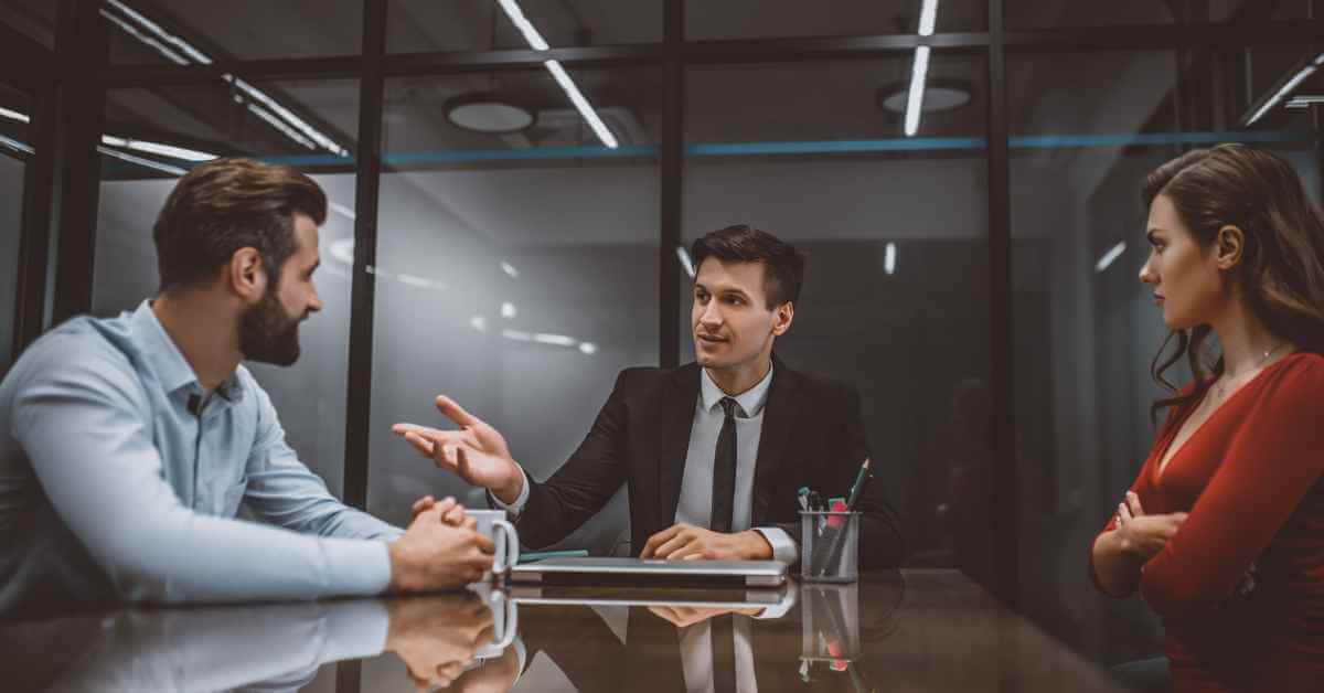 An attorney guiding a man and woman through divorce mediation