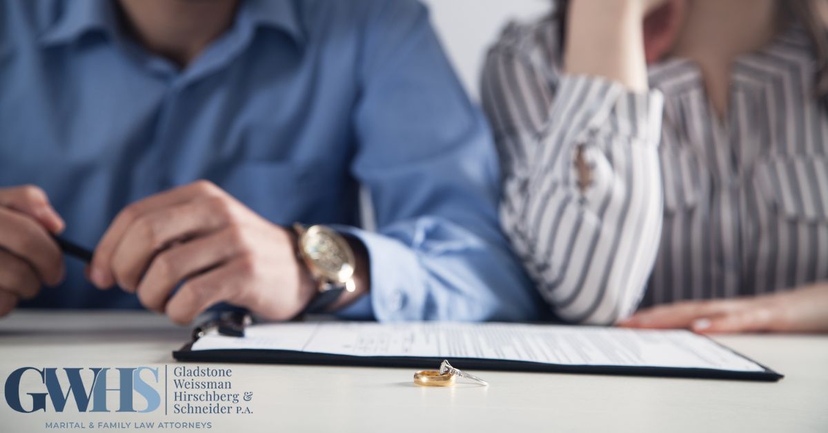 two people sitting at a table with their wedding rings on a table