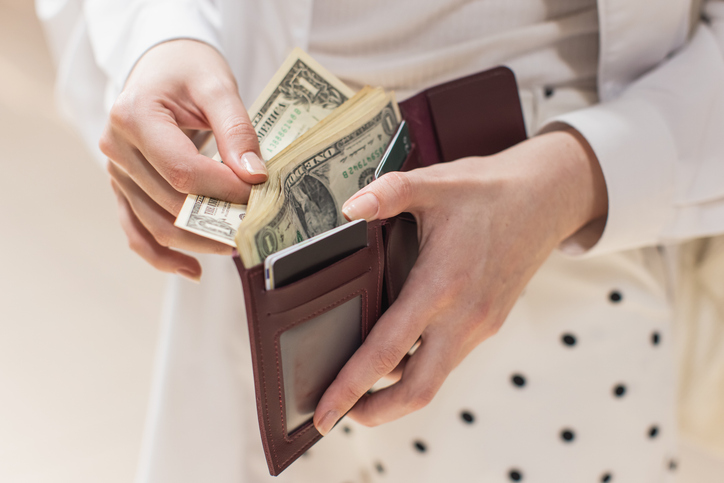 woman counting money in a wallet