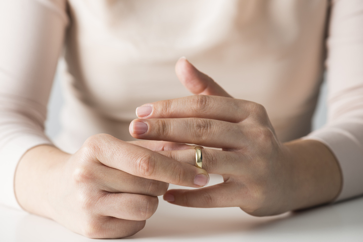 woman removing wedding ring